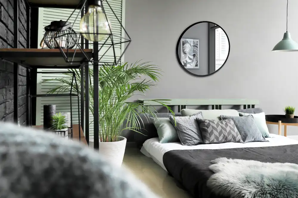 Round mirror hanging in a black frame
