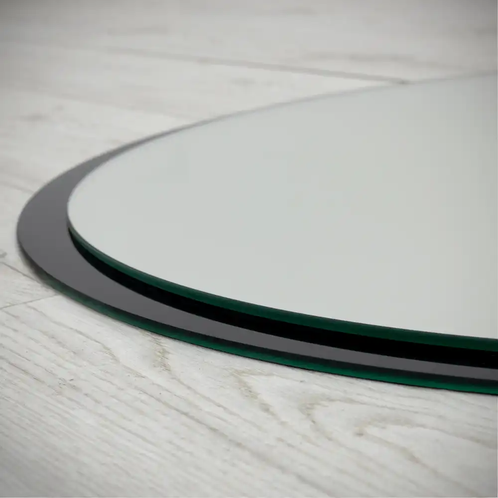 Round mirror hanging in a black frame