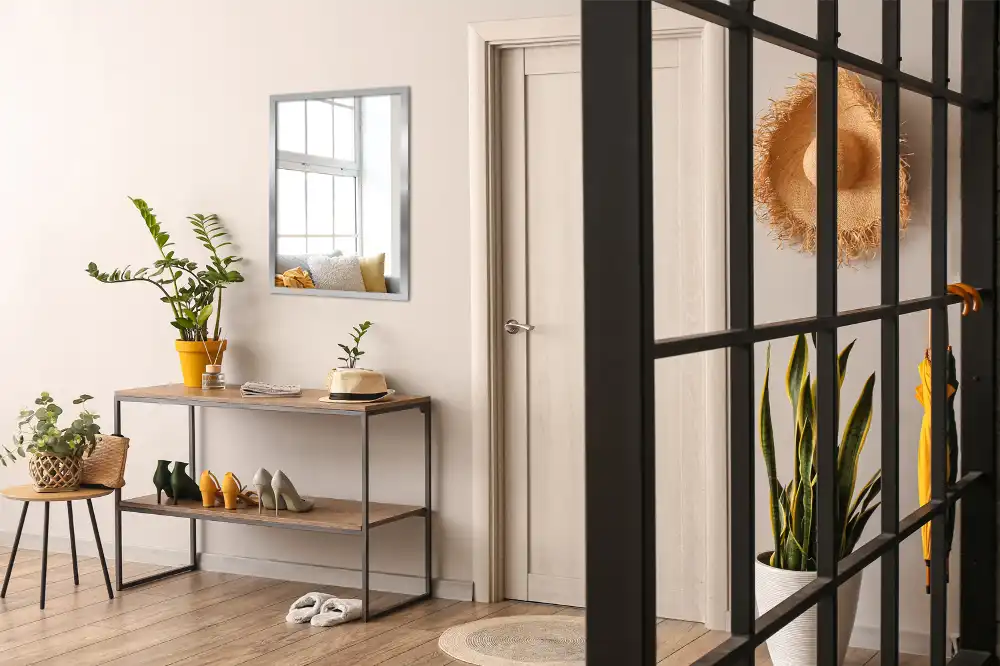 Rectangular wall mounted mirror with a silver frame